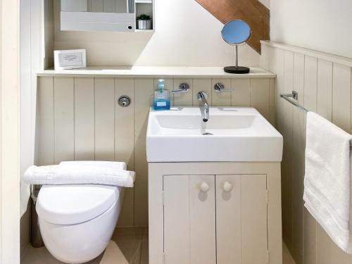 a small bathroom with a toilet and a sink at The Cart House in Helmsley
