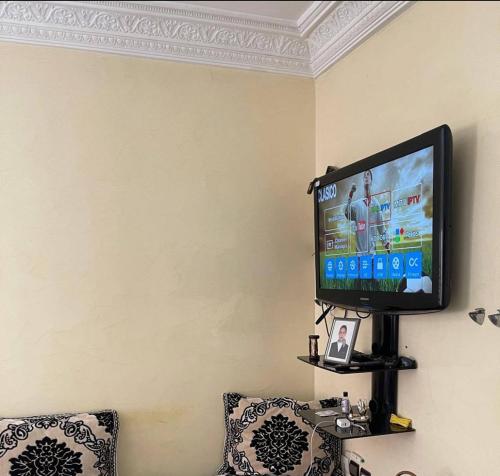 a flat screen tv hanging on a wall at Calme, plage 8 min, tout proche in Temara
