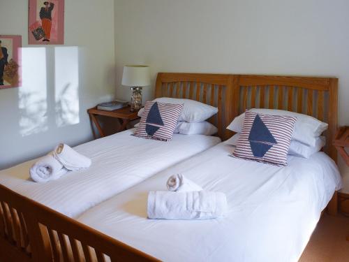 two beds with towels on them in a bedroom at Shadycombe Lodge in Salcombe
