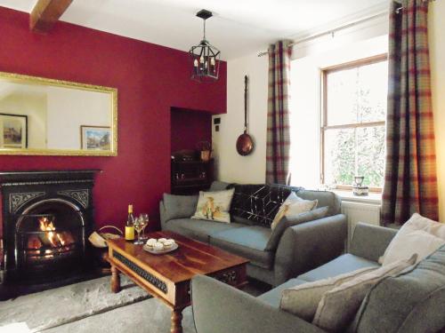 a living room with a couch and a fireplace at Newburgh C Listed Townhouse in Newburgh