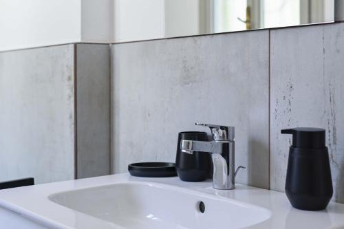 a bathroom sink with a faucet and a mirror at Villa Giovanna, Beautiful Rooms - by Host4U in Solto Collina
