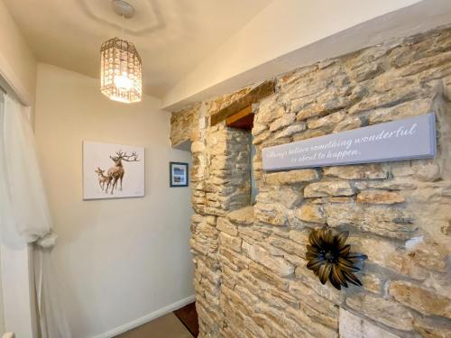 a room with a stone wall with a sign on it at The Nest in Hawthorn