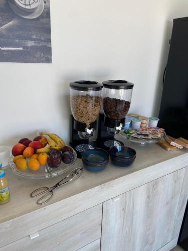 a wooden counter with two glasses of food and fruit at B&B Scirocco e Tramontana in Gallipoli