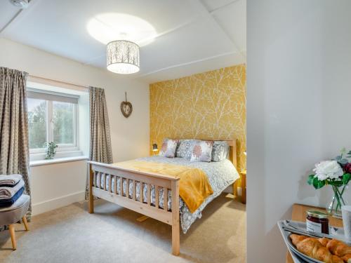 a bedroom with a bed and a window at South View in Haydon Bridge