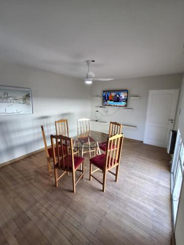 a dining room with a table and four chairs at Apart de la Plaza in San Fernando del Valle de Catamarca