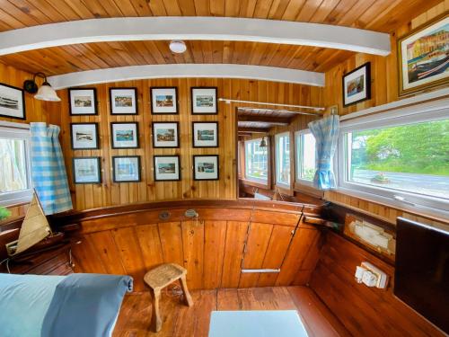 a room with wood paneling and a tv in a boat at The Prince - Uk42204 in Clachan of Glendaruel