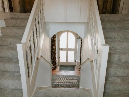 a staircase leading up to a door in a house at Farmhouse - Ukc6630 in Pentney