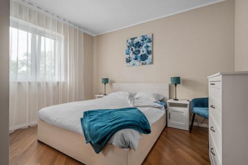 a white bedroom with a bed and a window at Wunderschöner Neubau Bungalow Mit Privatem Pool Und Jacuzzi in Vozilići