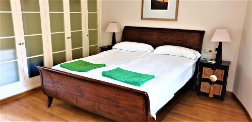a bedroom with a large bed with two green pillows on it at 5 Sterne Villa Großer Luxus in La Playa de Tauro