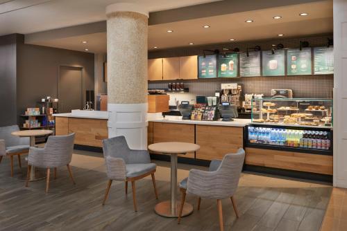 a restaurant with tables and chairs and a counter at Best Western Parkway Hotel Toronto North in Richmond Hill
