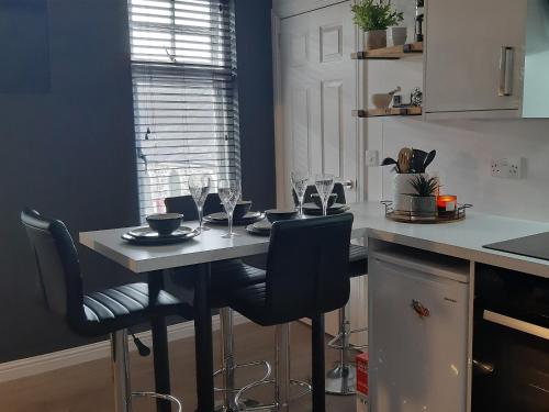 a kitchen with a table with wine glasses on it at Castlegate in Lanark