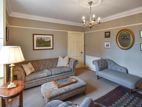 a living room with a couch and a table at Rennie House in East Linton