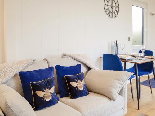 a living room with a couch with blue pillows at Lime Tree Lodge in Castle Douglas