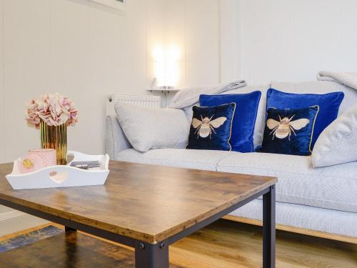 a living room with a couch with blue pillows at Lime Tree Lodge in Castle Douglas