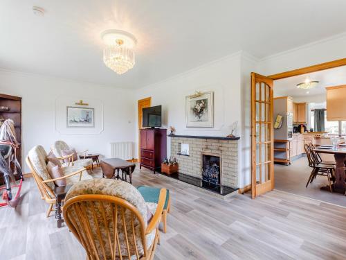 a living room with a fireplace and a dining room at Drummond House Uk42979 in Brackley