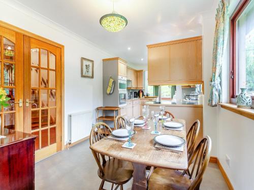 a dining room with a table and chairs in a kitchen at Drummond House Uk42979 in Brackley
