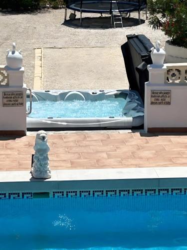 a swimming pool with a toy dog sitting next to it at Garten und Pool in San Vicente del Raspeig