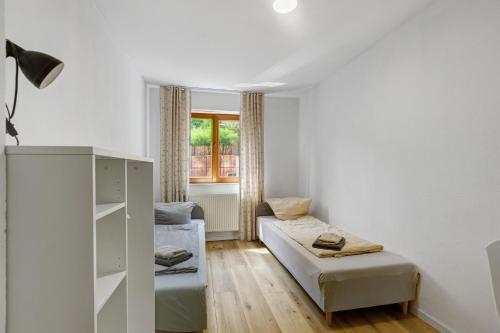 a room with a bed and a couch and a window at Bergblick Apartments in Radolfzell am Bodensee