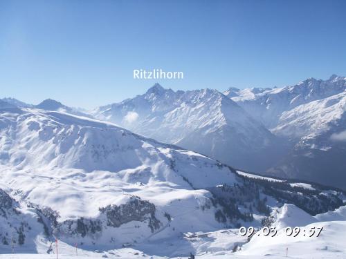 a snow covered mountain with mountains in the background at Hotel-Restaurant Alpina in Innertkirchen