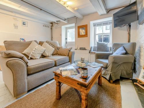 a living room with two couches and a coffee table at Fishermans Cottage in St Ives