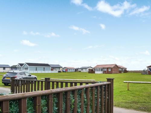 a car parked in front of a yard with houses at Yeolde Woodern Country View Seashak - Uk46596 in Bridlington