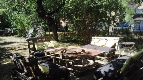 a wooden table and chairs in a yard at Spacious 3 bedrooms apartment in Briançon