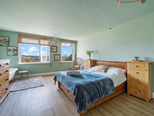 a bedroom with a large bed and a bath tub at Chapter Meadow in Worcester