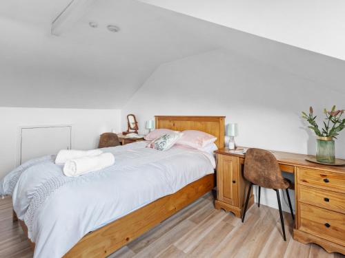a bedroom with a bed with a wooden desk and a desk at Chapter Meadow in Worcester