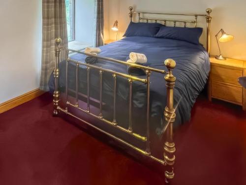 a bed with a metal frame in a bedroom at Stewards Bothy - Uk48303 in Berwick-Upon-Tweed