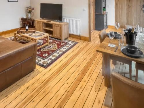 a living room with a couch and a table at Stewards Bothy - Uk48303 in Berwick-Upon-Tweed