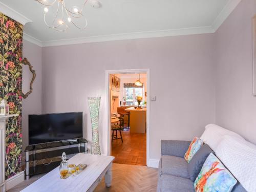 a living room with a couch and a table at Bliss House in Madeley