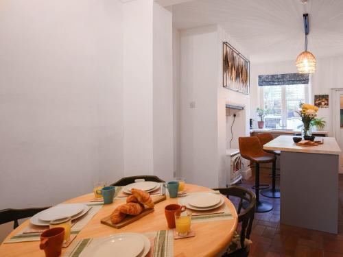 a dining room with a table with plates and food on it at Bliss House in Madeley