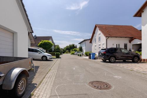 a street with cars parked on the side of the road at Bergblick Apartments in Radolfzell am Bodensee