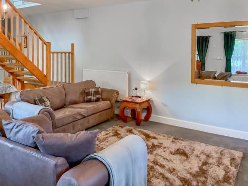 a living room with a couch and a table at Court Place in Misterton