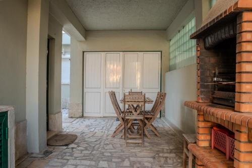 a dining room with a table and chairs on a patio at Caparica Beach House Holiday Home in Costa da Caparica