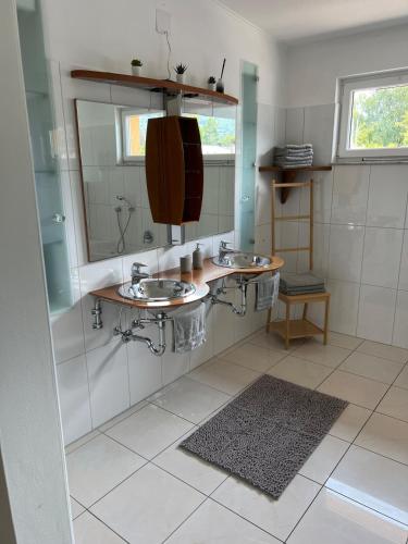 a bathroom with two sinks and a mirror at Vacation home Oxy in Ferlach