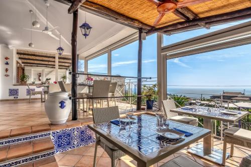 a dining room with a view of the ocean at Casa Simi in Nerano