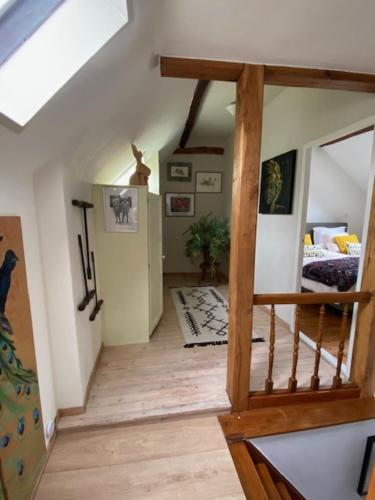 a living room with a staircase and a bedroom at boerderij, voorhuis in Schimmert