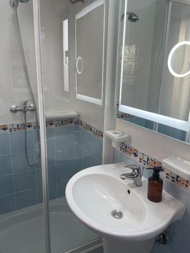 a bathroom with a sink and a shower at Bright & Airy 3 Bedroom Apartment in Naxxar