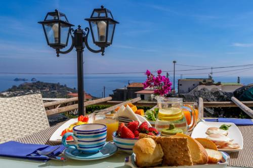 a table with a breakfast of bread and fruit at Casa Simi in Nerano