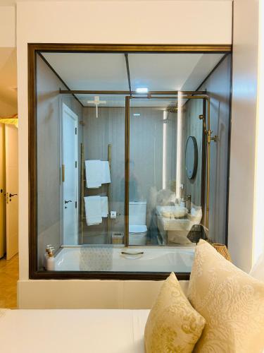a bathroom with a large glass window with a tub at Zen Garden Apartment in Vera
