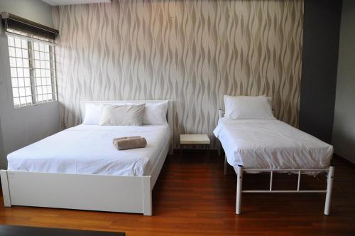 a bedroom with two beds with white sheets and a chair at GRAYHAUS BU4 5BR House - Bandar Utama, near 1 Utama - Stay Only NO EVENTS in Petaling Jaya