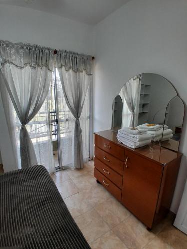 a bedroom with a dresser and a mirror and a bed at Cozy 2 in Canning