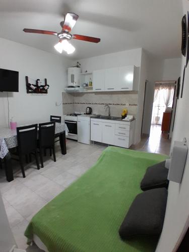 a kitchen and living room with a green rug at Cozy 2 in Canning