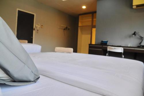 a bedroom with a white bed with two chairs at GRAYHAUS BU4 5BR House - Bandar Utama, near 1 Utama - Stay Only NO EVENTS in Petaling Jaya