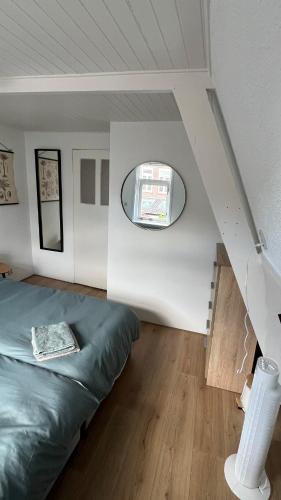 a bedroom with a bed and a round window at Large Family House Alkmaar in Alkmaar