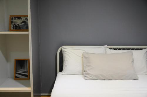a bed with white sheets and pillows in a room at GRAYHAUS BU4 5BR House - Bandar Utama, near 1 Utama - Stay Only NO EVENTS in Petaling Jaya