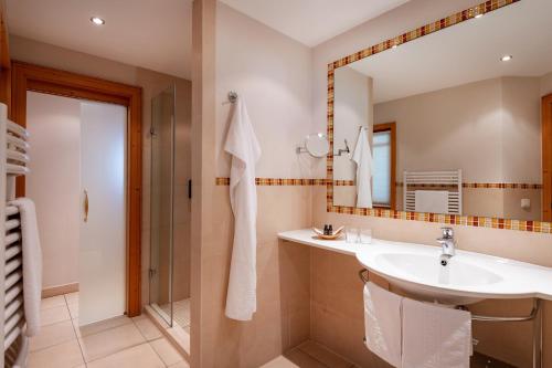 a bathroom with a sink and a mirror at Hotel Elisabeth, 4 Sterne Superior in Kirchberg in Tirol
