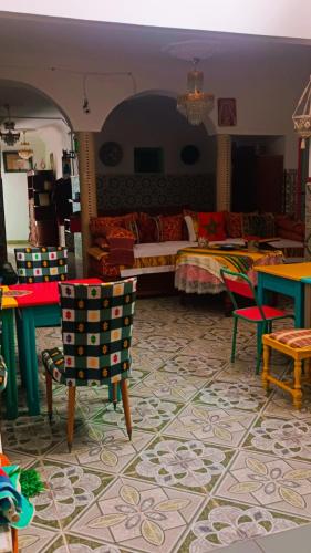 a living room with a bed and chairs in a room at Riad SULTANA lateral seaview in Saidia 