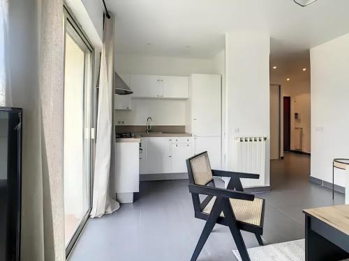 une cuisine avec une table et une chaise dans une pièce dans l'établissement Superbe Appartement 2p avec place de parking, à Antibes